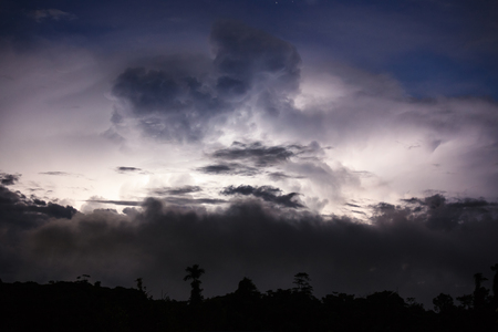 Thundercloud illuminated by lightningの写真素材