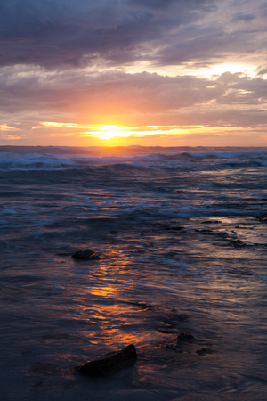 Sea scape waves sunset light glow and cloudy skyの写真素材
