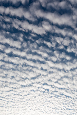 Cirrocumulus clouds against blue sky background pattern