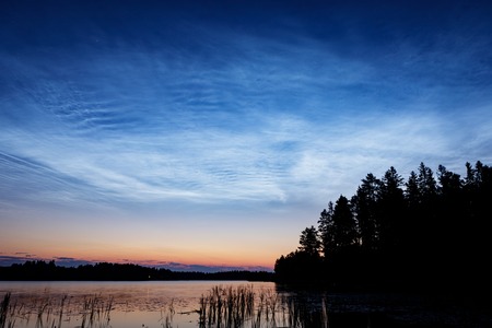 Night shining clouds over lake in Finlandの写真素材