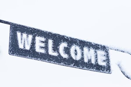 Welcome sign close-up covered in frost at winterの写真素材