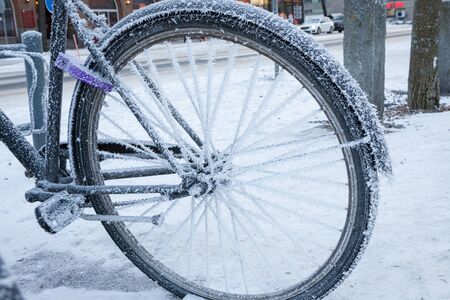 Bicycle covered in frost close-up at winter day in cityの写真素材