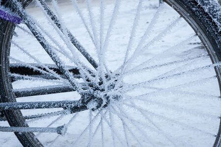 Bicycle covered in frost close-up at winter day in cityの写真素材