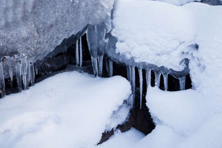 Row of big frosty icicles in natureの写真素材