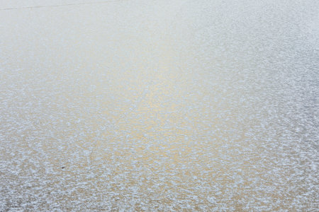Frozen lake surface and snow at winter dayの写真素材