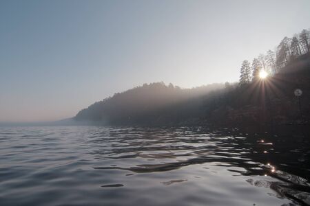 Autumn forest.
river fog sunrise
Light through the treesの写真素材