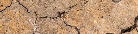 Old concrete cement with cracks and natural destruction from time and weather conditionsの写真素材