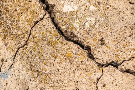 Old concrete cement with cracks and natural destruction from time and weather conditionsの写真素材