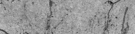 A high resolution old concrete cement with cracks and natural destruction from time and weather conditions. Non-color, monochrome black and white photo.の写真素材