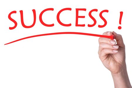 Hand writes word success with red marker on transparent white background.の写真素材