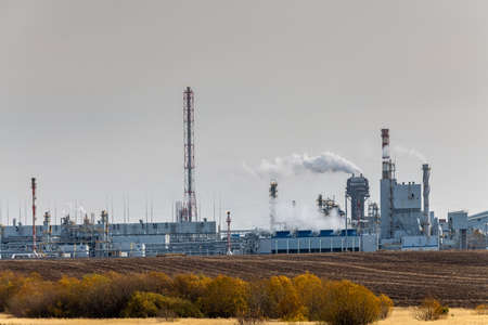 Chemical Plant factory with smoke stack. Smoke emission. Petrochemical industry with distillation column, drum and pipe in oil and gas. Ecology and environmental protection problems, air pollutionの写真素材