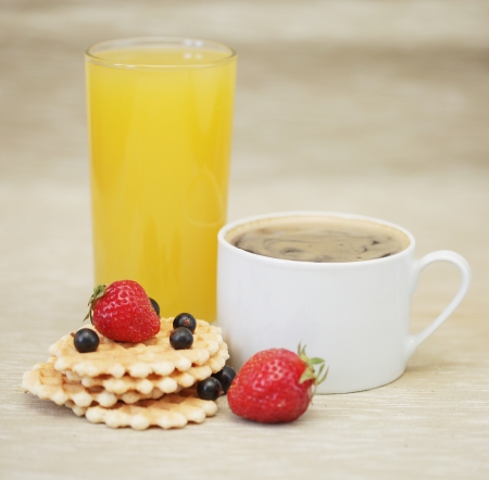 coffee, orange juice and wafer with strawberriesの写真素材