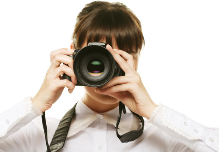 Beautiful young woman with camera.Isolated on white backgroundの写真素材
