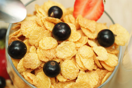 Breakfast - cornflakes with glass of milk. Wafes, black currants and strawberries.
