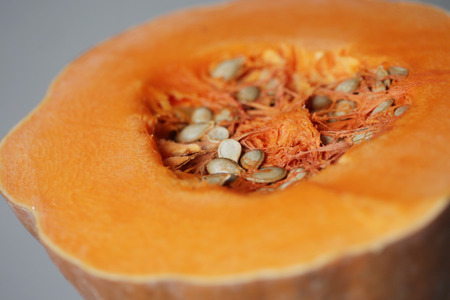 freshly cut butternut pumpkin on a gray wallの写真素材