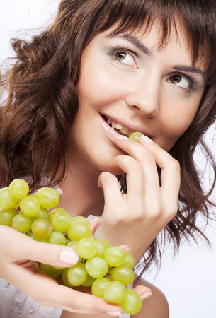woman with green grapesの写真素材