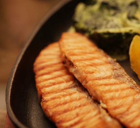 Grilled salmon steak served with spinachの写真素材