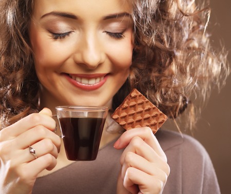 attractive woman with coffee and cookiesの写真素材