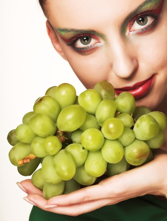 woman with green grapesの写真素材