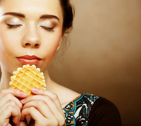 happy lwoman with cake waferの写真素材