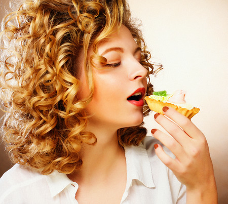 beautiful smiling young woman with a cakeの写真素材