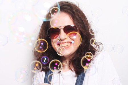 Young surprised woman wearing sunglasses. Emotional portrait.の写真素材