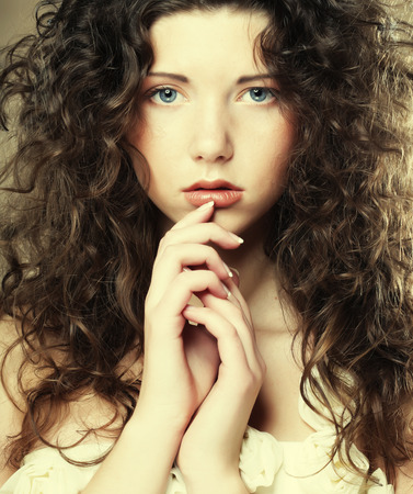 Image of beautiful young woman with curly hairの写真素材