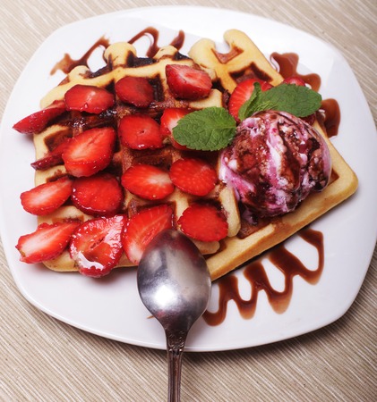 delicious waffles with strawberry and ice creamの写真素材