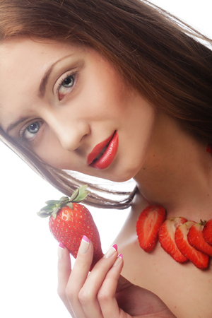 young woman with strawberry on the white backgroundの写真素材