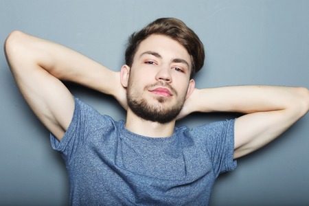 life style, emotional and people concept: Portrait of sexy man over grey backgroundの写真素材