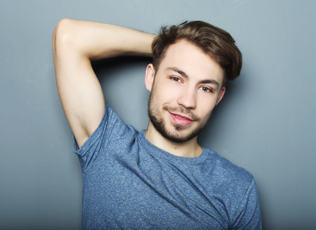 life style, emotional and people concept: Portrait of sexy man over grey background