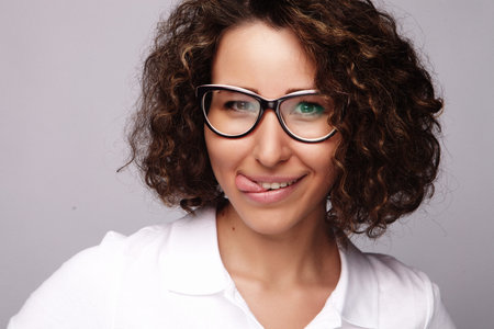 lifestyle and people concept:Young happy woman with curly hair over white background