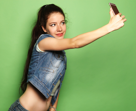 Pretty hipster girl taking selfie.の写真素材