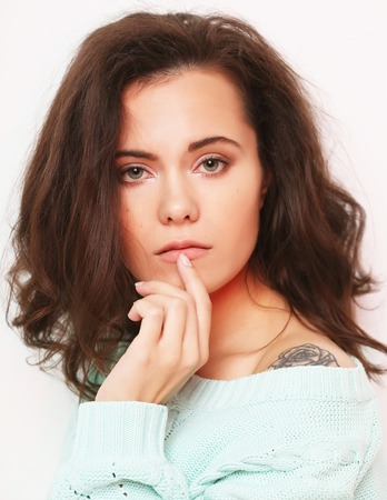 young woman wearing casual clothes, posing on white backgroundの写真素材