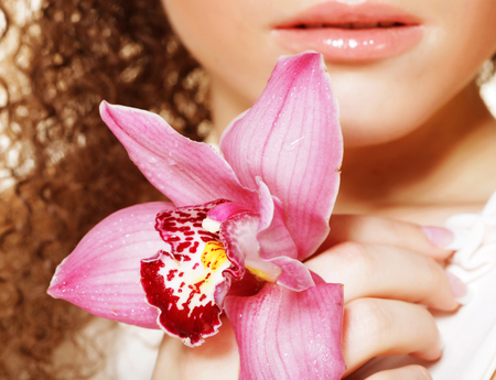 beautiful  young woman with pink orchidの写真素材