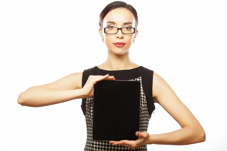 Smiling beautiful young brunette businesswoman showing blank no-の写真素材