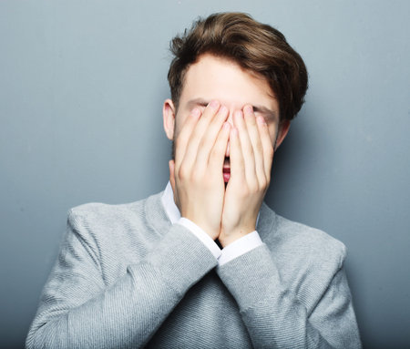 portrait of a young businessman afraid and scared of something