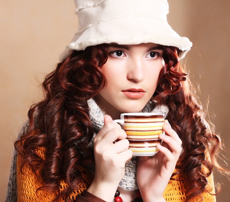 pretty woman wearing white hat drinking coffeeの写真素材