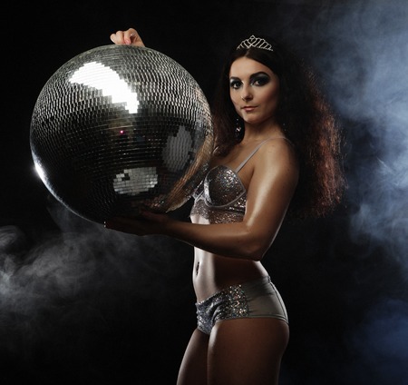 dancer brunette girl wearing lingerie with disco ballの写真素材