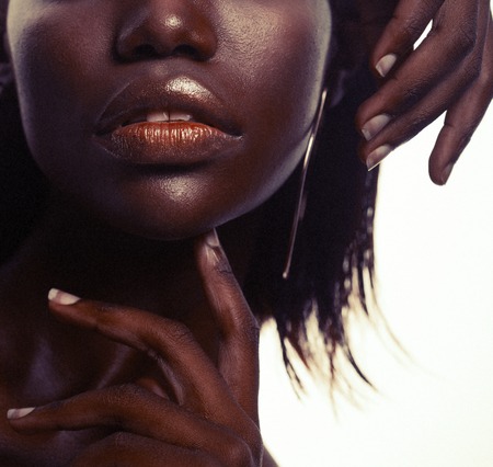 Beauty concept: Portrait of a sensual young African woman with colored make upの写真素材