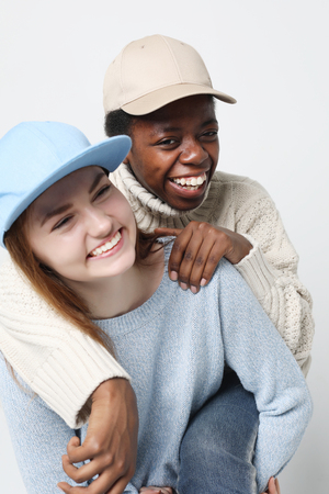 Multiethnic friendship concept. Cheerful European and African women.の写真素材