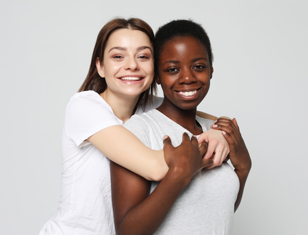 Shot of happy interracial homosexual couple huggingの写真素材