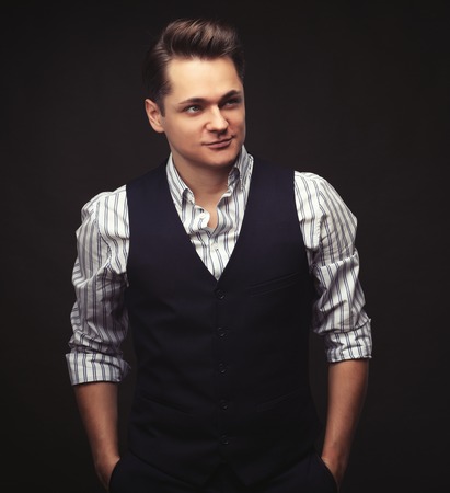 young man model posing over dark backgroundの写真素材