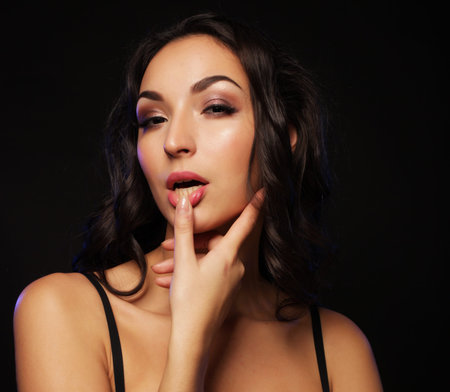 Beautiful young woman wearing sexy lingerie over black background