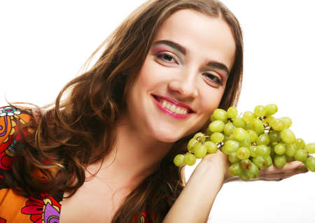 portrait of a girl with a bunch of grapes isolated on white backgroundの写真素材