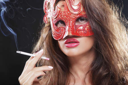 woman smokes in the darkの写真素材
