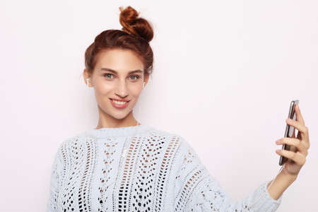 lifestyle and people concept: Portrait of young teenage girl using mobile phoneの写真素材