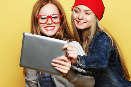 two hipster girls friends taking selfie with digital tabletの写真素材