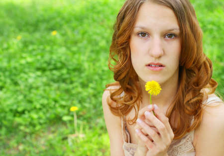 Young redhair woman wearing summer dress in parkの写真素材