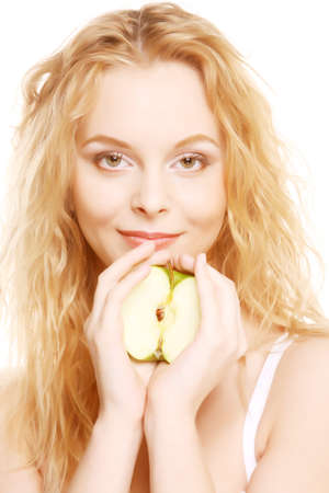 woman with an apple looking towards cameraの写真素材
